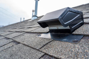 How to Increase Your Roof's Energy Efficiency. Image of a static vent installed on a shingle roof for passive attic ventilation.